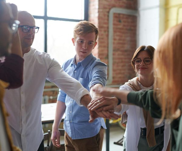 Group of diverse people smiling and interacting in a support group setting.